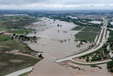 an area with roads, houses, and other buildings that is underwater in multiple areas