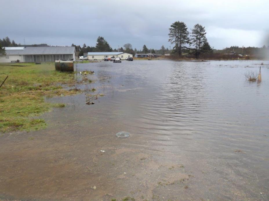 Flooding from the Quinault River and Pacific Ocean across the Quinault Indian Nation Village of Taholah.