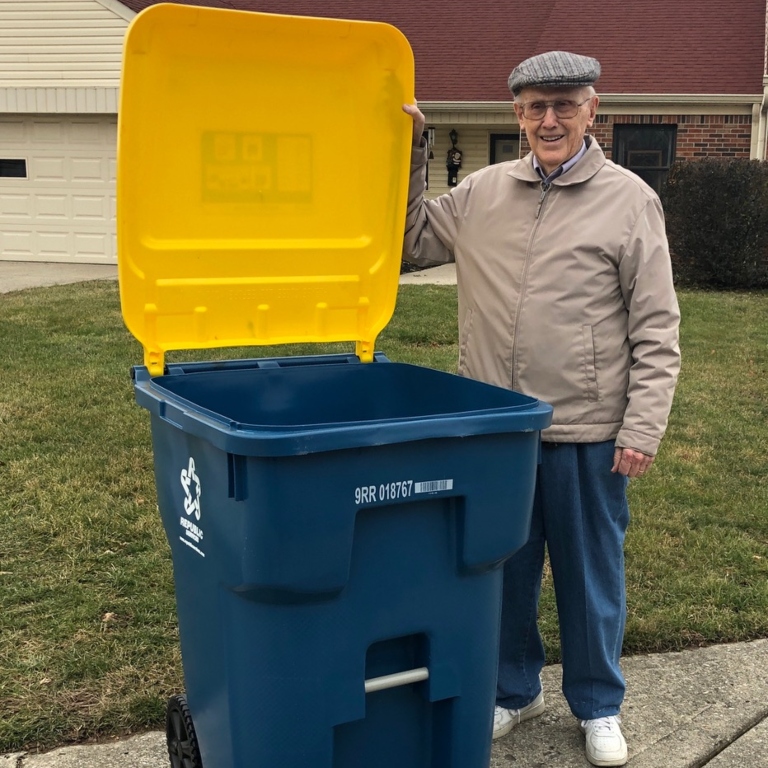 Decorative - Bob Glass standing with a recycling bin