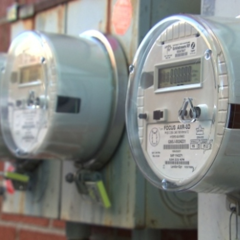 Energy meters against a brick wall