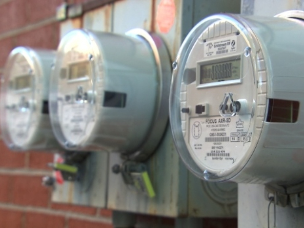 Electric meters against a brick wall