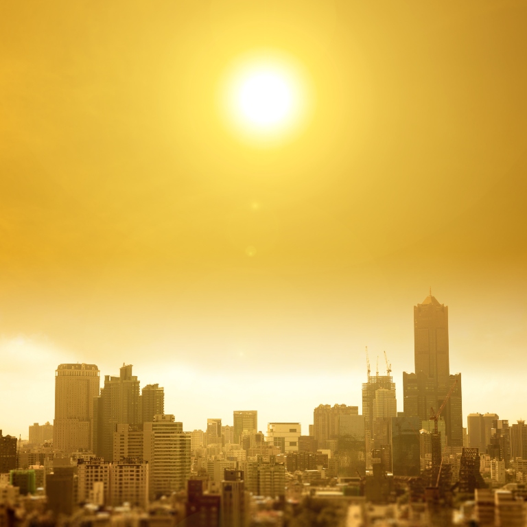 A city scape with a hot sun